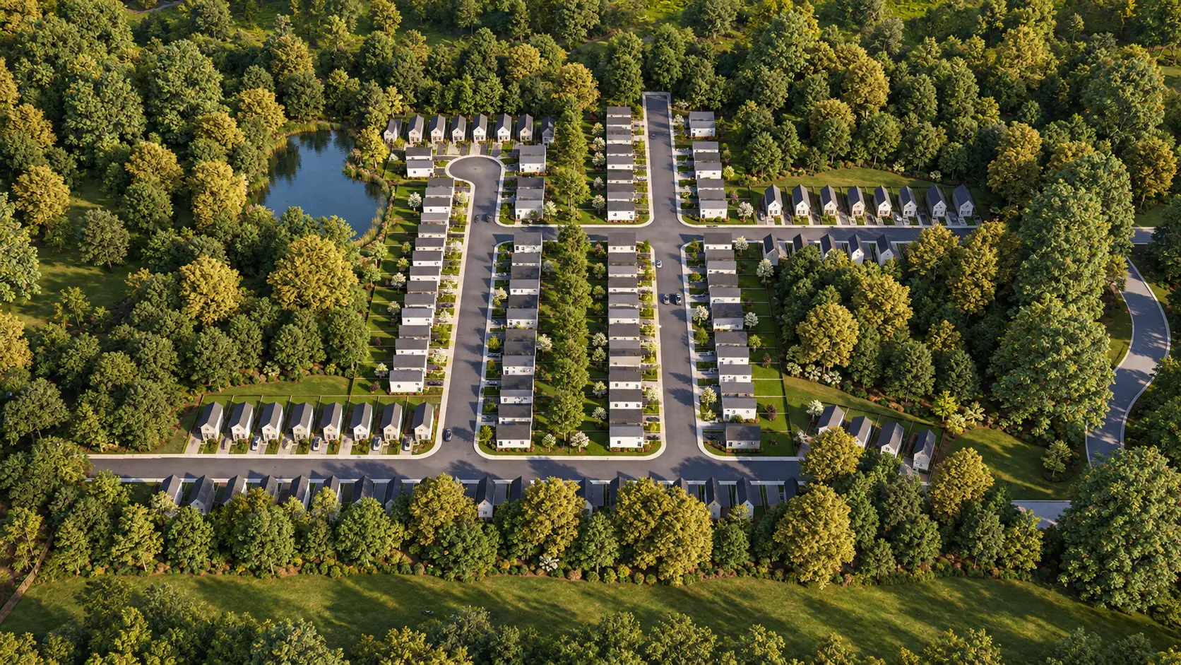 Woodley Manor Masterplan — Site Map in Alabama: Aerial rendering of a 130-lot master-planned community featuring cottage-style homes, landscaped green space, and a central lake surrounded by mature trees.
